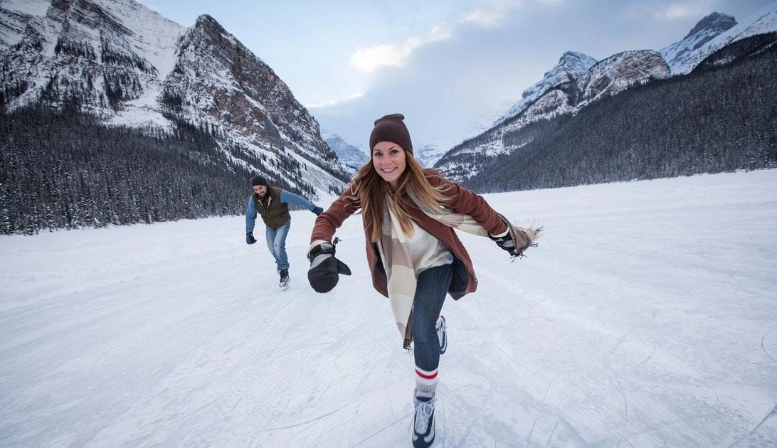 A women skates on Lake Louise, Banff National Park, AB