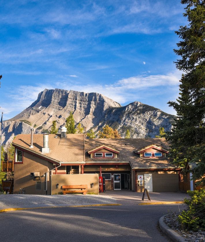 Exterior of the HI Banff Alpine Centre with Mount Rundle in the background