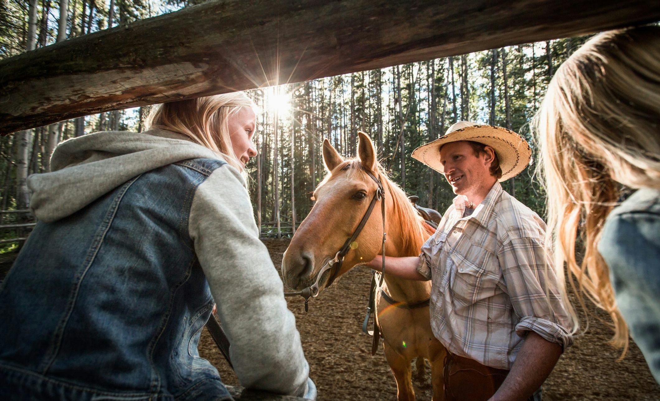  A cowboy introduces his horses to girls in Banff and Lake Louise, AB