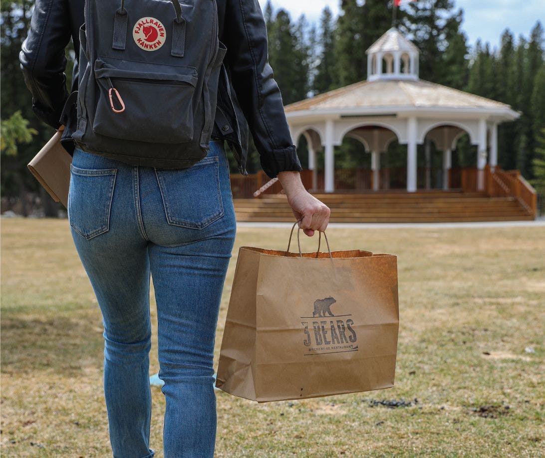 Arriving to Central Park with a Three Bears Brewery and Restaurant takeout bag