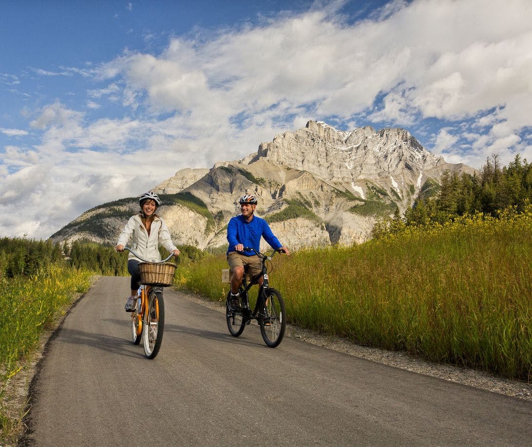 Cyclists make their way down the Legacy Trail in Banff, AB
