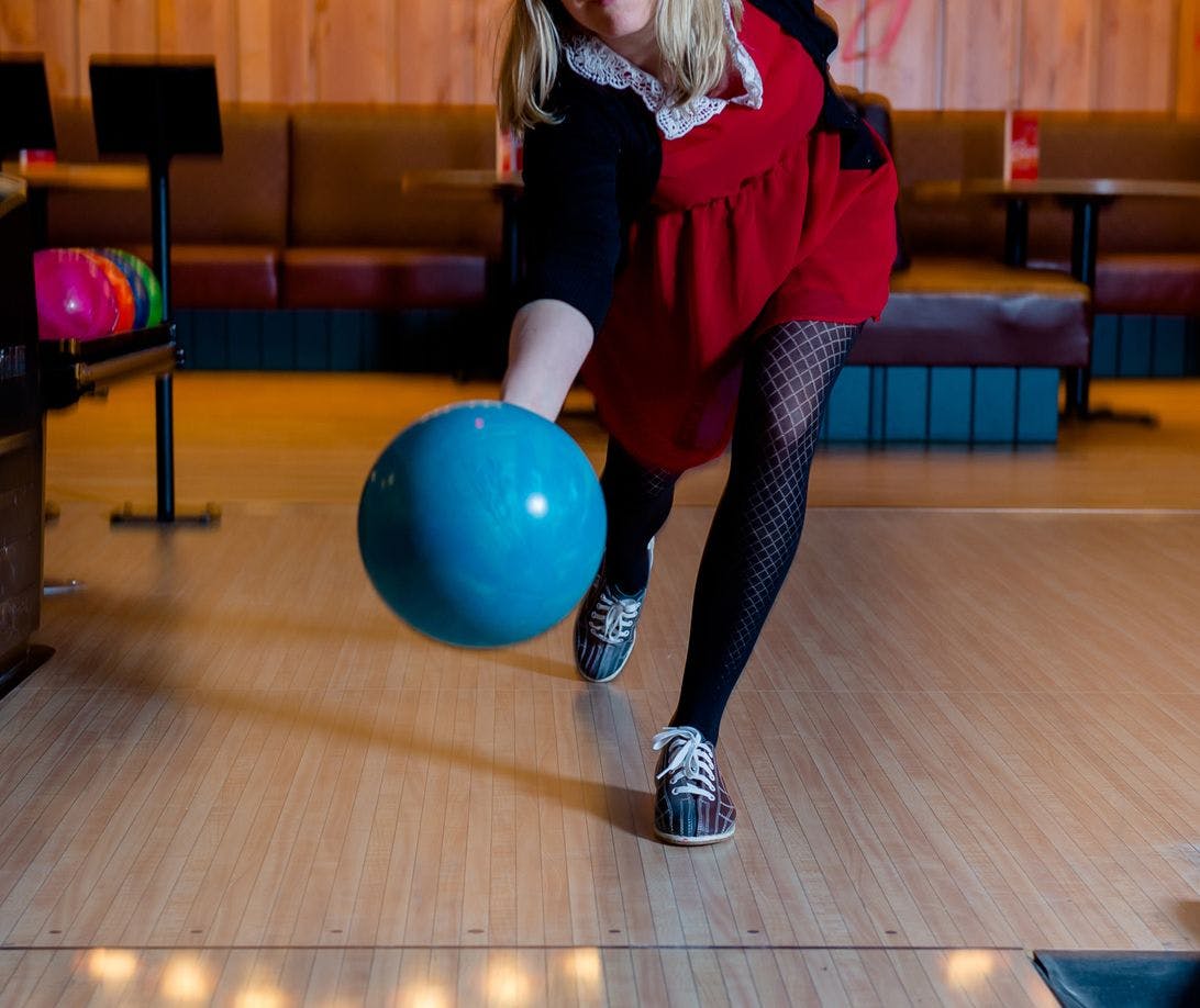 A women bowls indoors at the High Rollers Bowling Centre in Banff, AB
