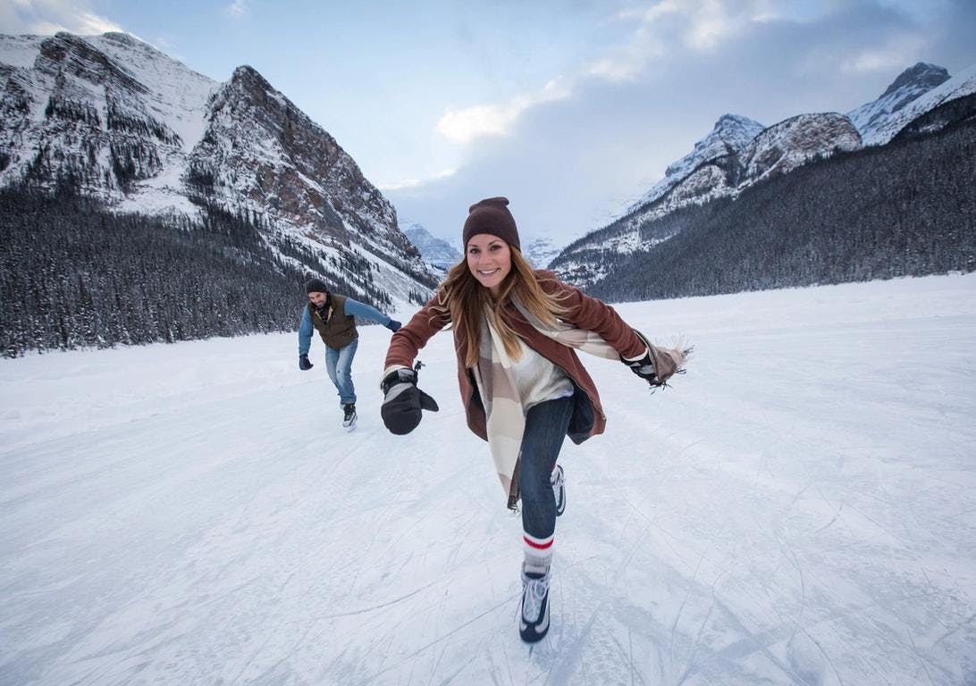 A women skates on Lake Louise, Banff National Park, AB