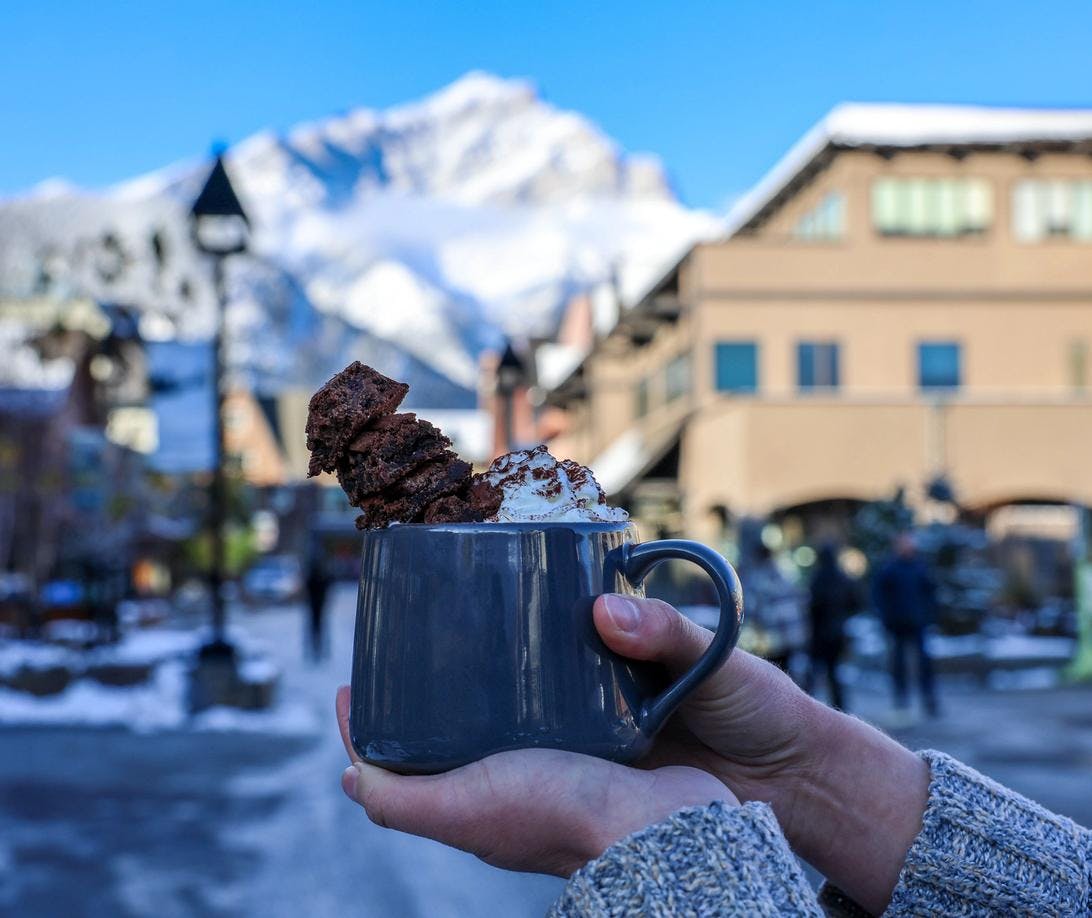 A hot chocolate on Bear Street with Cascade Mountain in the background.