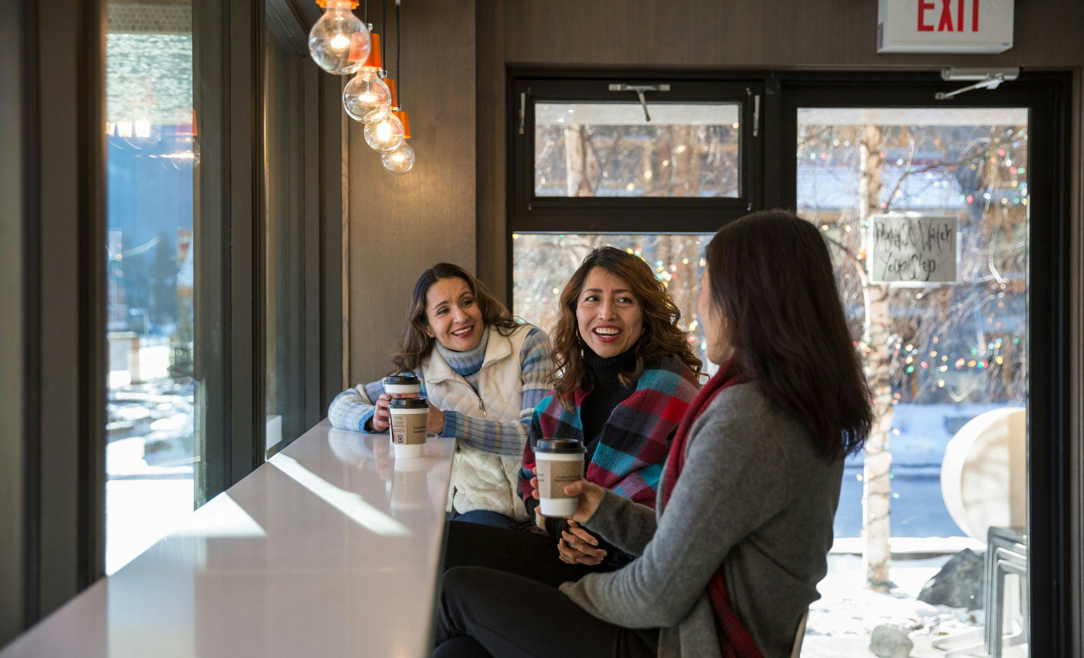Three friends drinking espresso coffee at Whitebark cafe