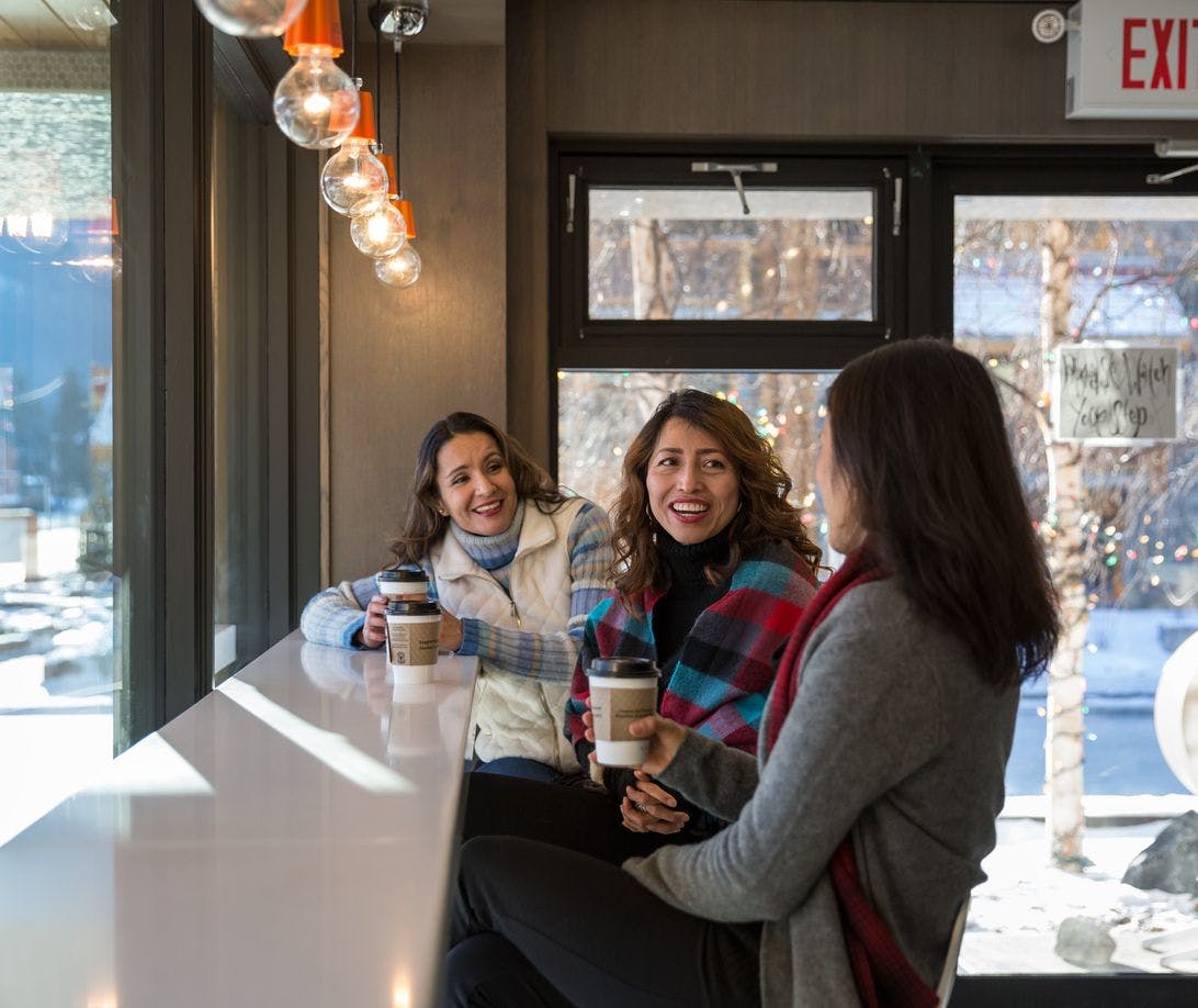 Three friends drinking espresso coffee at Whitebark cafe