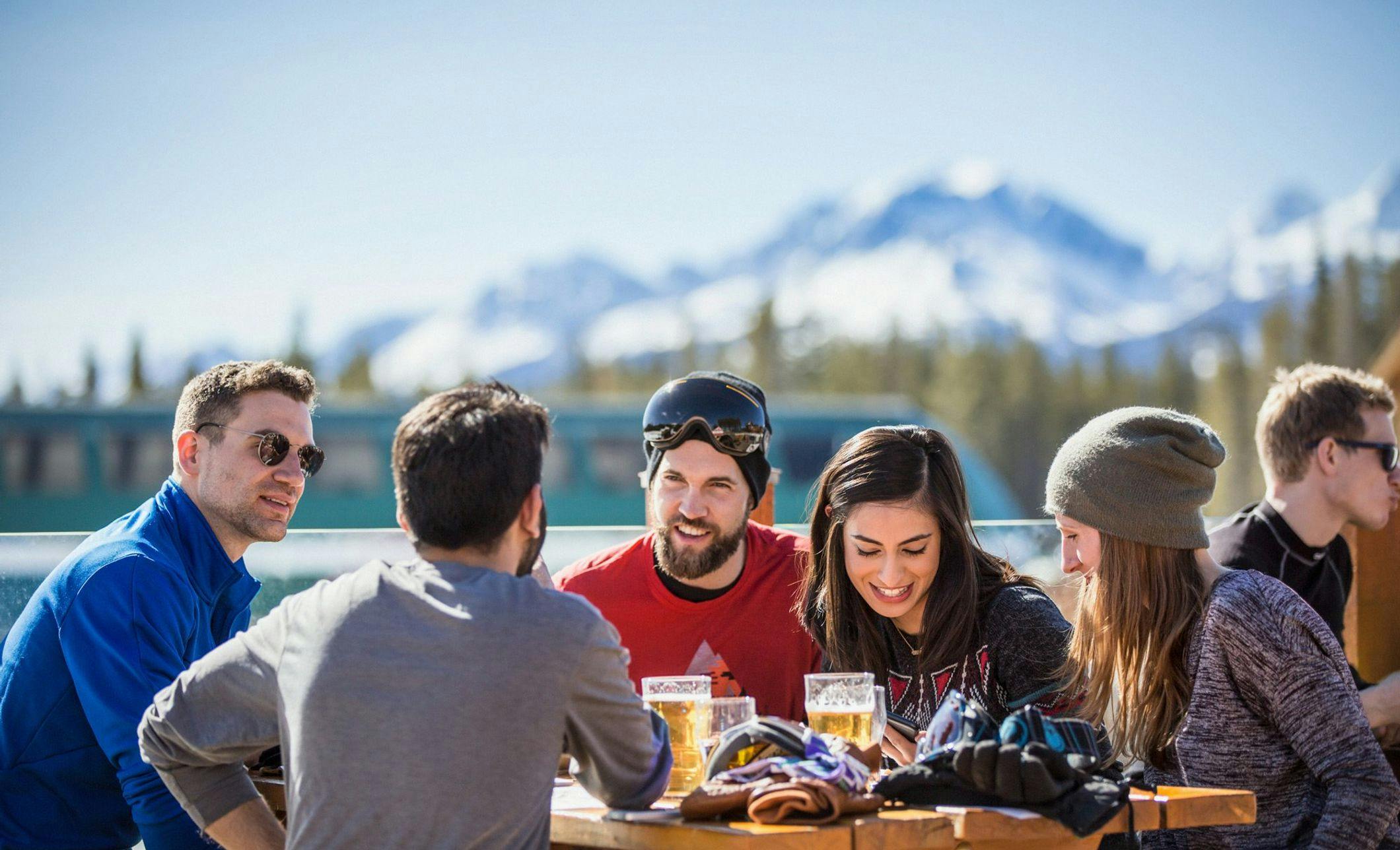 A group of friends enjoys some post-ski apres in Lake Louise, AB