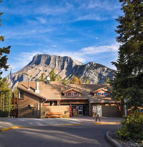 Exterior of the HI Banff Alpine Centre with Mount Rundle in the background