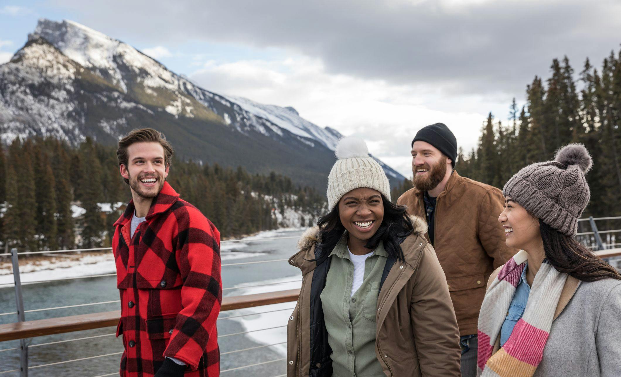 Friends Walking Across the Banff Pedestrian Bridge