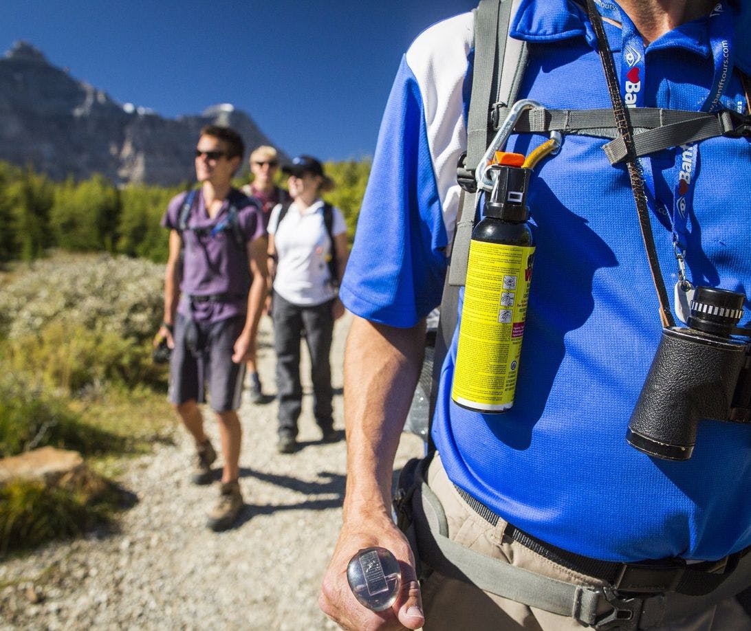 Hiker with bear spray attached to his backpack
