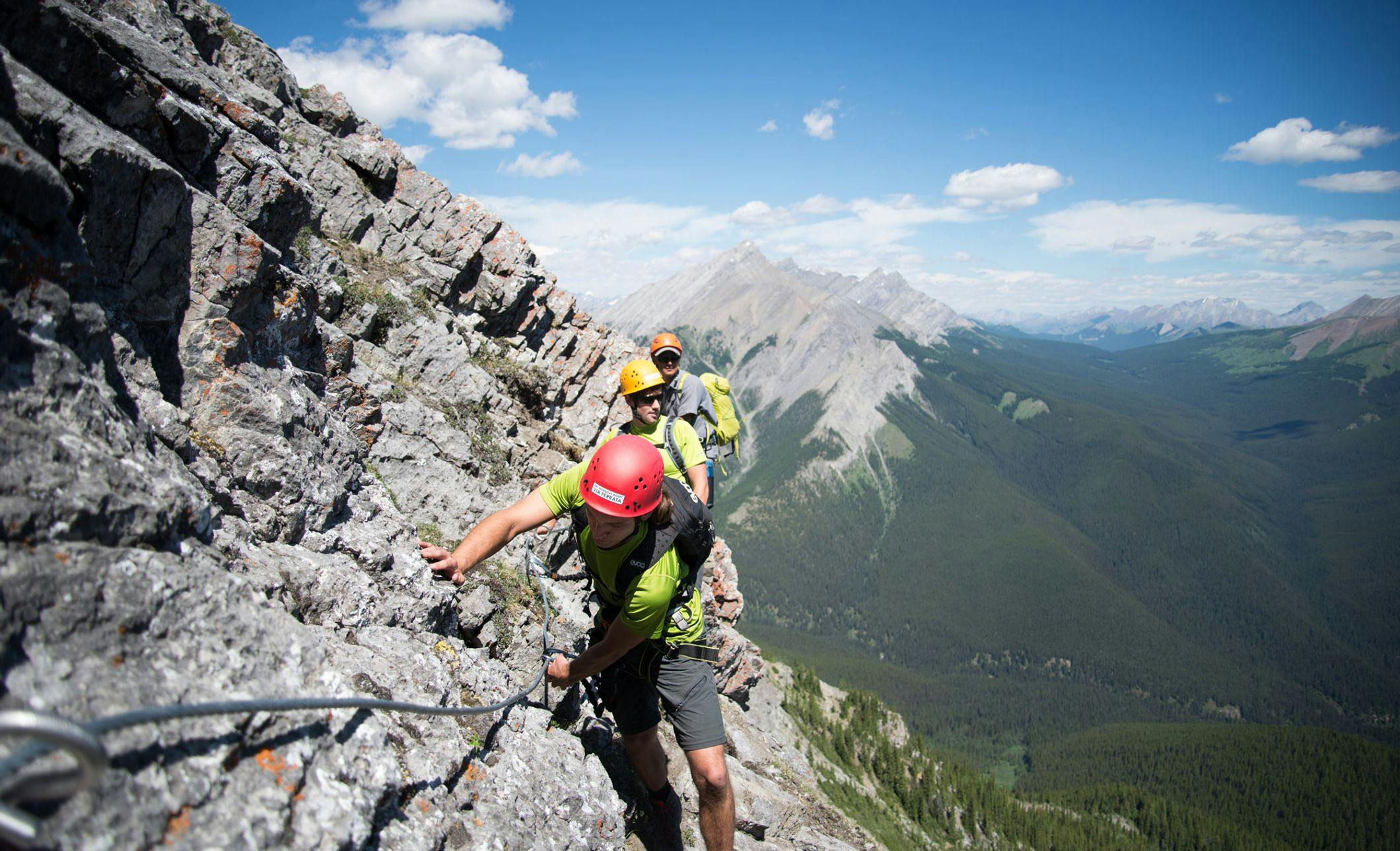 A climber ascends the Via Ferrata on Mt. Norquay, Banff National Park, AB