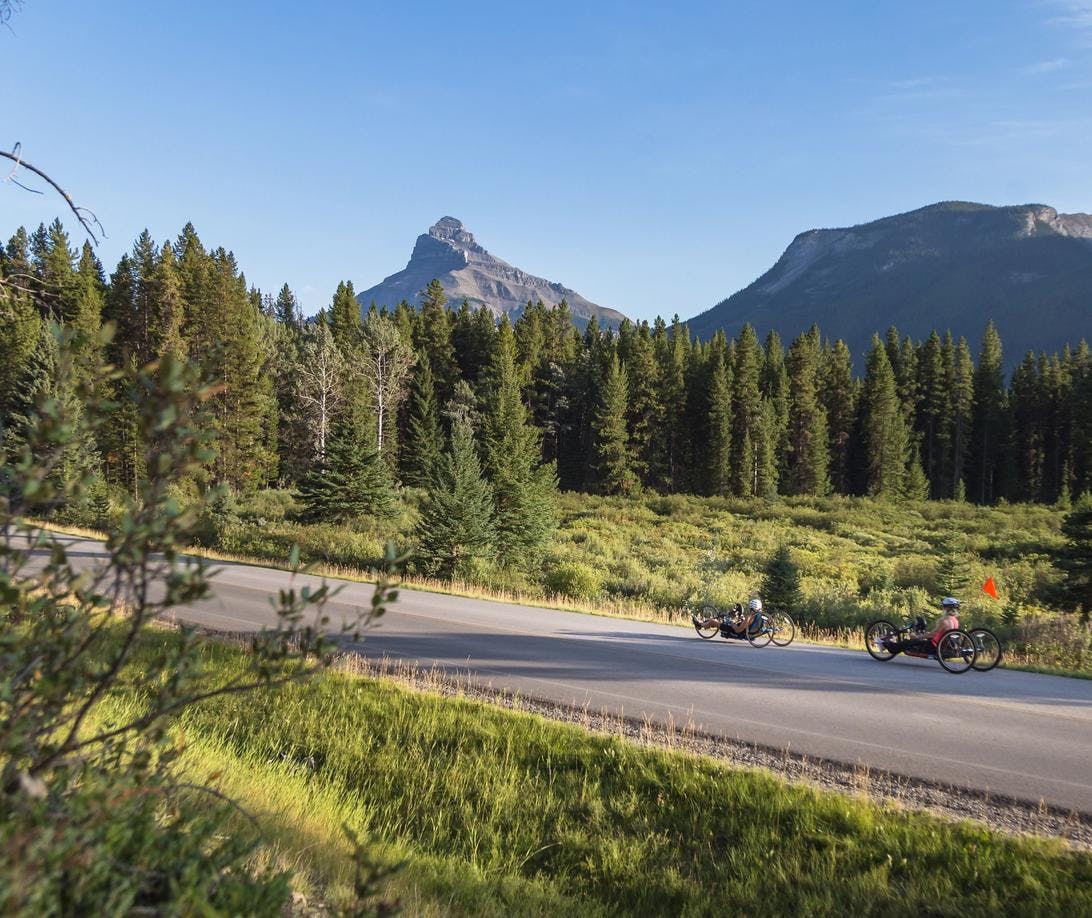Cyclists bike on the Bow Valley Parkway during the road closure.