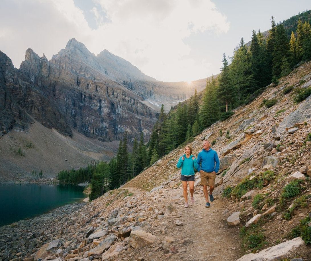 Two people hike a trail in Banff National Park in the Canadian Rockies.