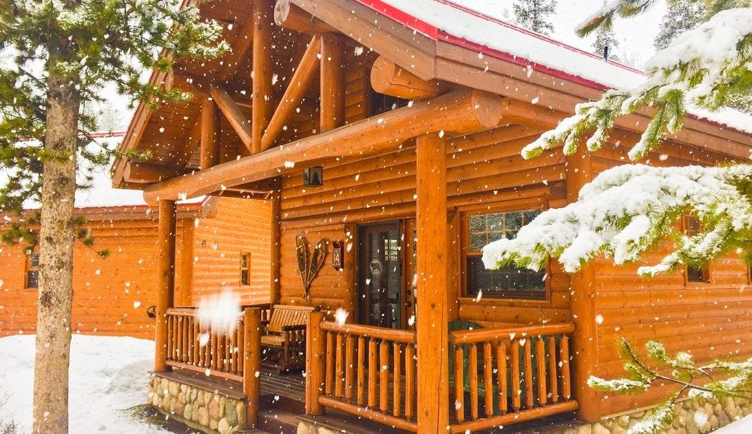 Snow falling around a wooden cabin at Castle Mountain Chalets in Banff National Park.