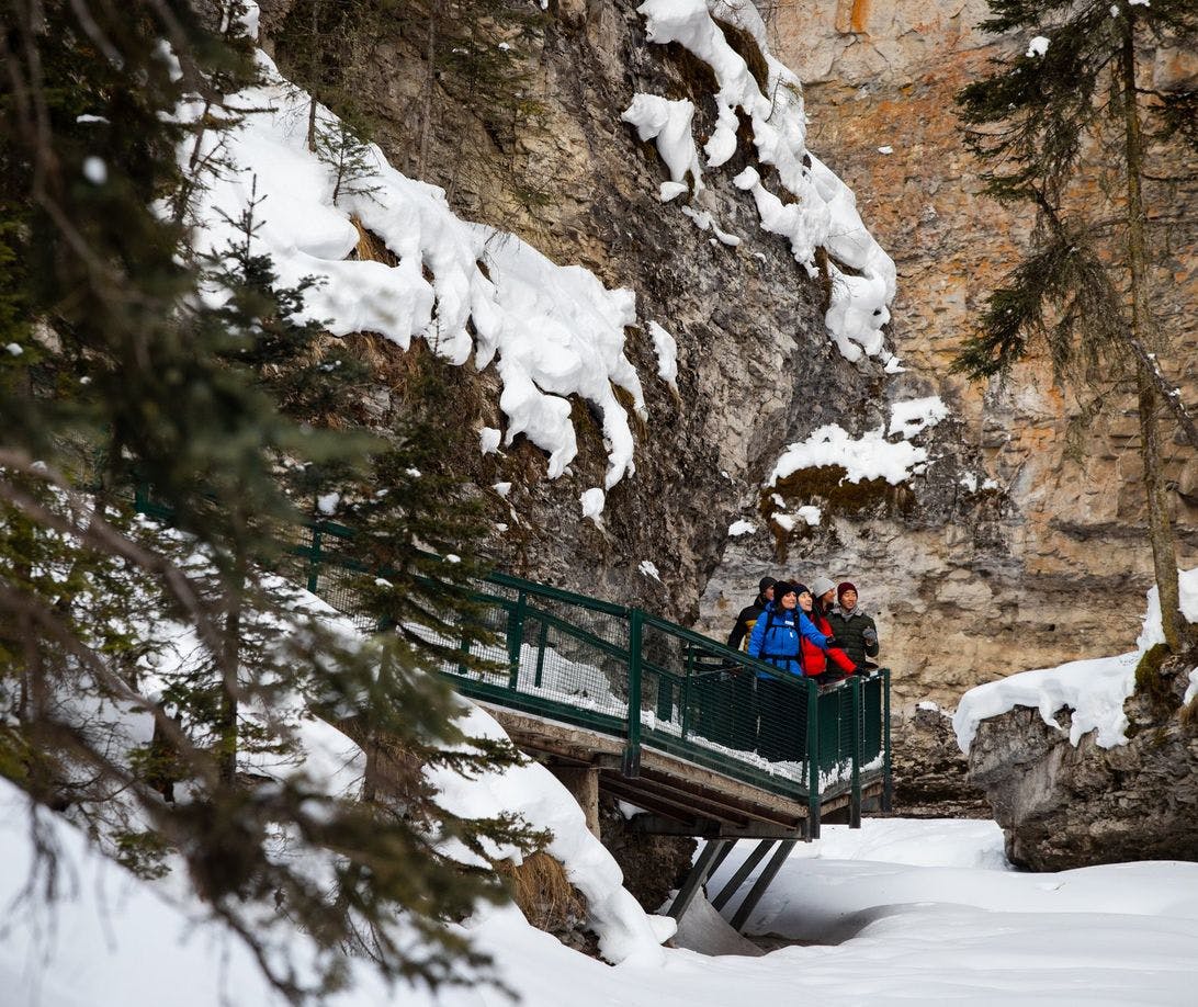 A guided tour traveling through Johnston Canyon in the winter