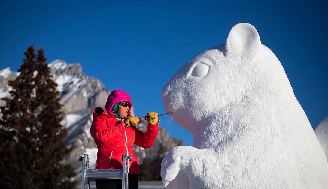 A carver makes a snow sculpture in Banff during SnowDays.