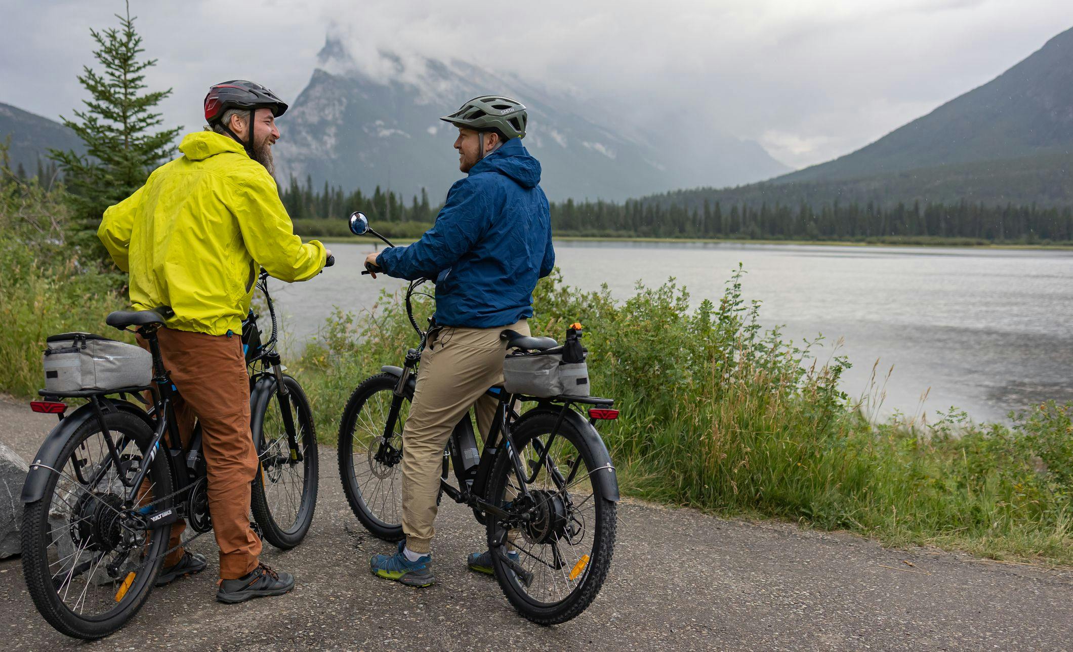 Two bike riders look at the view of Mount Rundle on Vermilion Lakes Road.