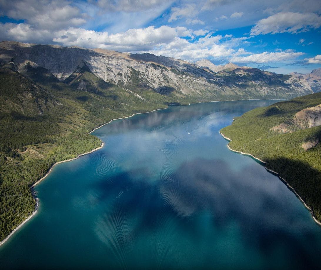 Just outside of the town Banff, Lake Minnewanka is a popular place for hiking, biking, fishing, canoeing, and swimming in Banff National Park.