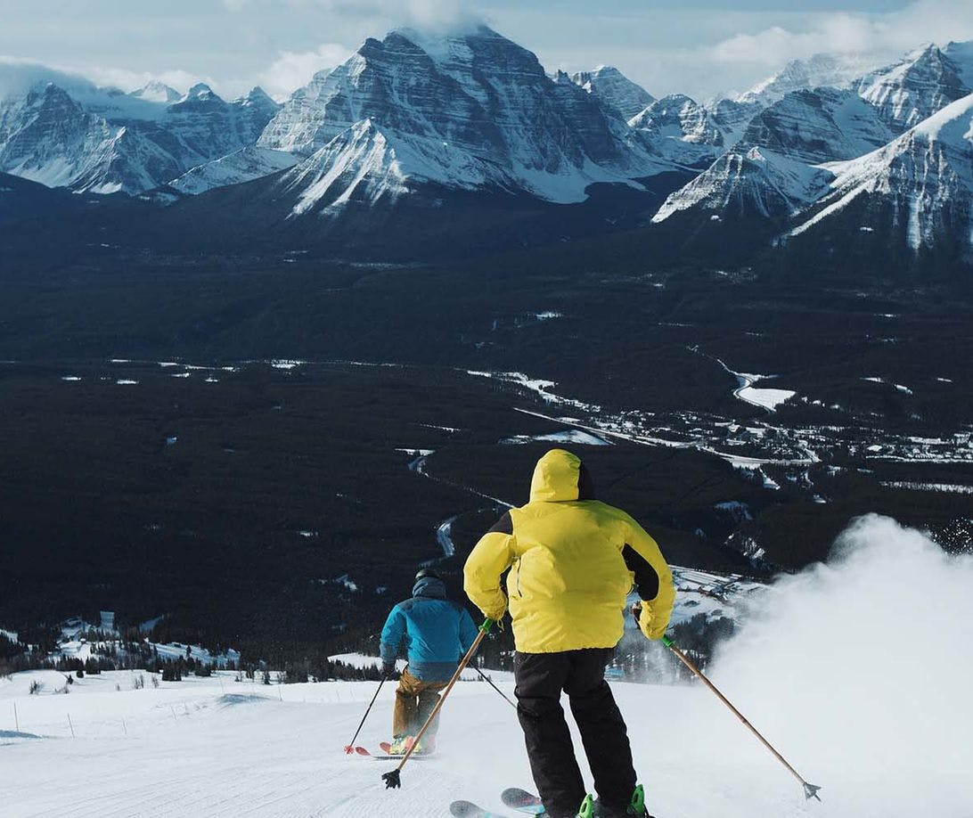 Two people ski down a run at the Lake Louise Ski Resort in Banff National Park.