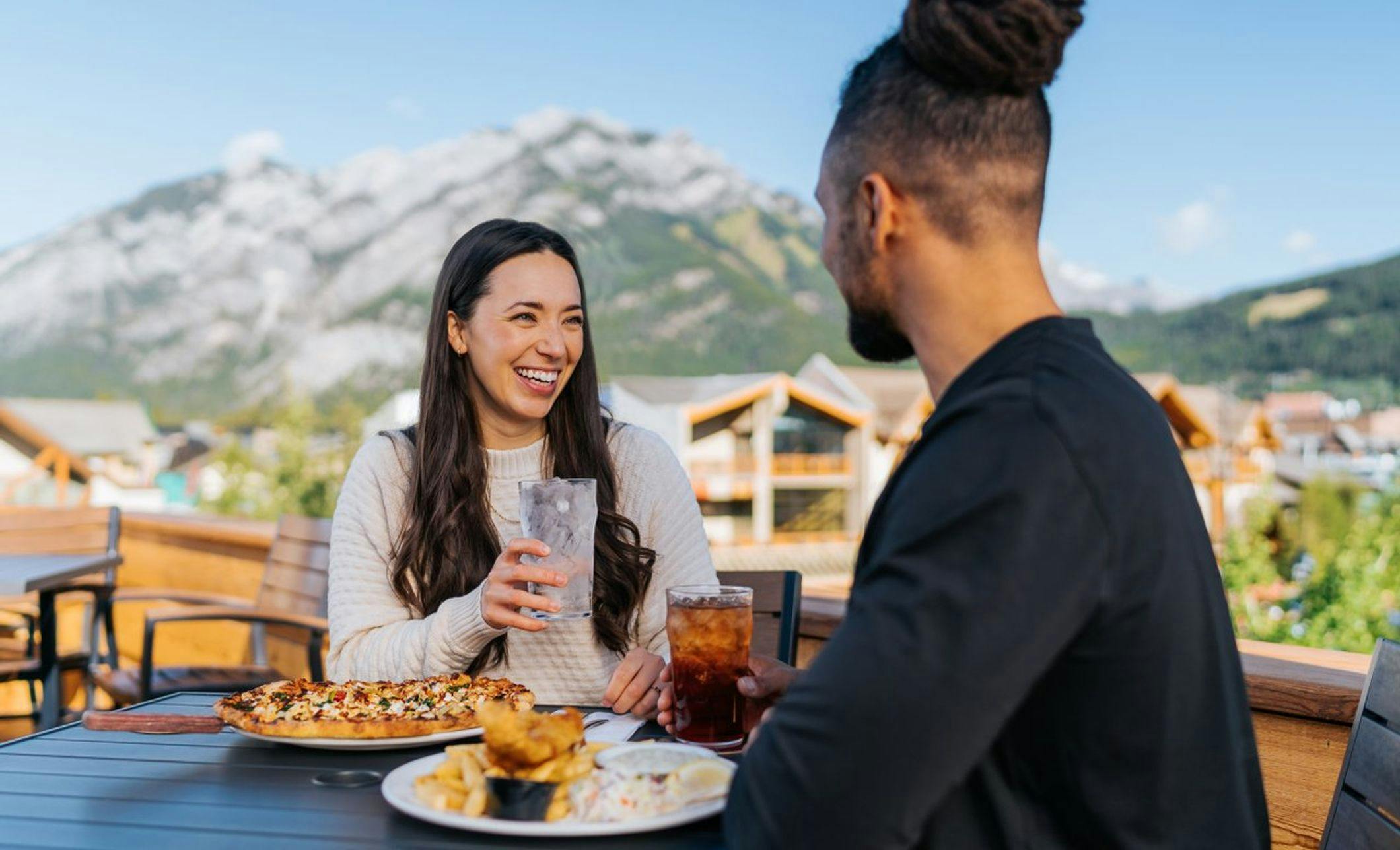 A couple enjoy a patio in Banff