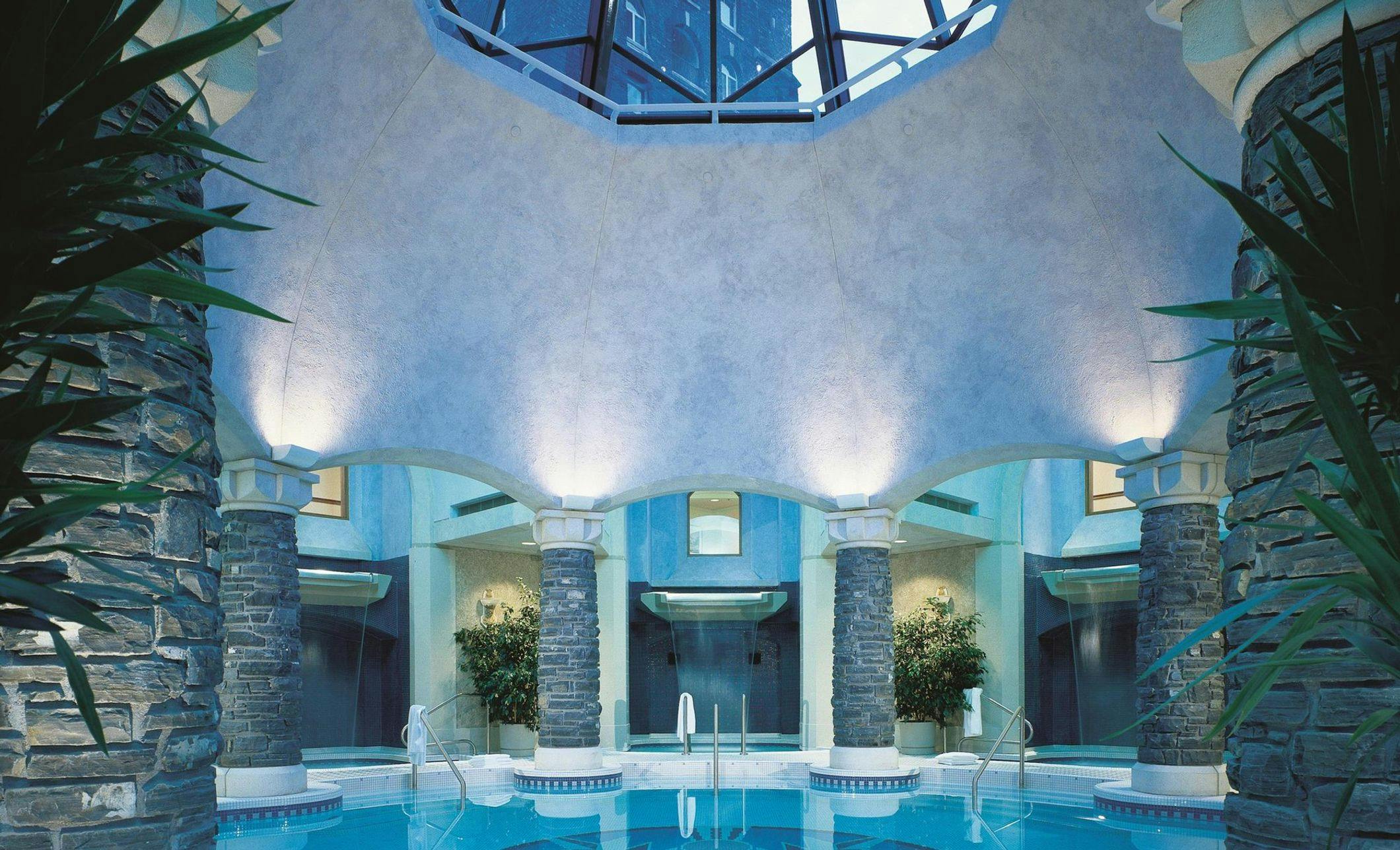 Mineral Pool surrounded by three waterfall plunge pools and a skylight in the ceiling