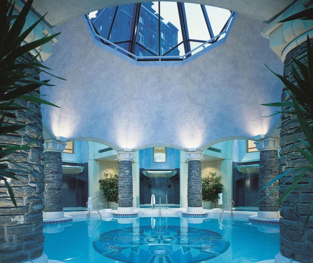 Mineral Pool surrounded by three waterfall plunge pools and a skylight in the ceiling