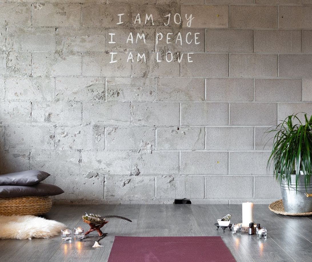 Yoga mat, candles, and soft pillows in a yoga studio
